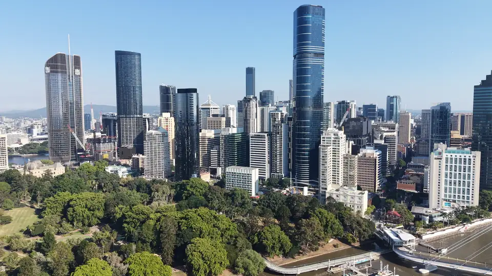 Aerial view of the Brisbane CBD skyline above the river and its parklands
