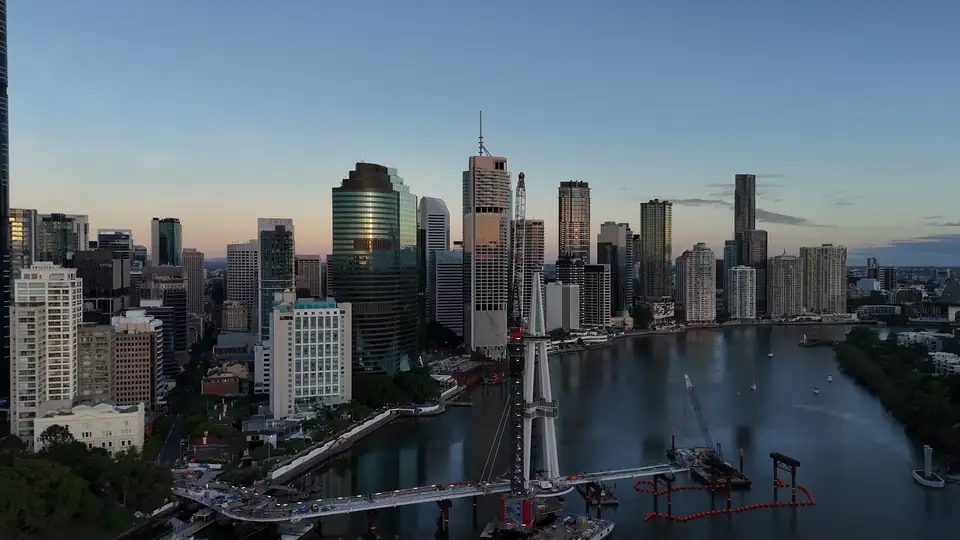 The Brisbane CBD skyline and river seen from the air above South Bank at dusk